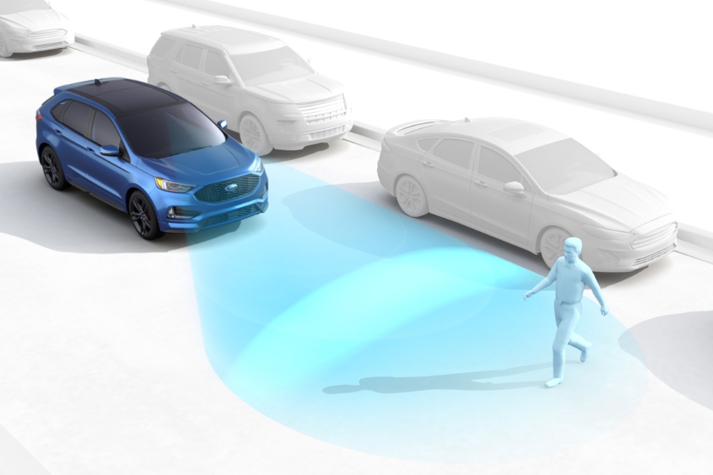 A graphic demonstrating the Pre-Collision Assist feature, showing a blue car detecting a pedestrian via a camera.