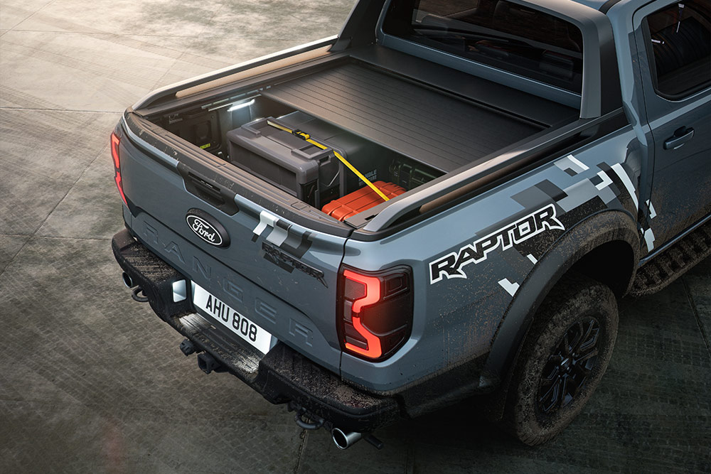 Rear view of a parked blue Ranger Raptor, showcasing the powered roller shutter.