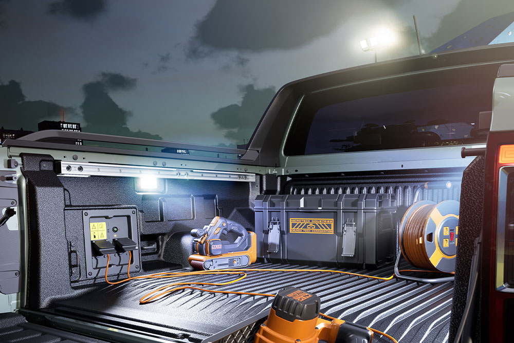 Close-up of the Ford Ranger PHEV’s truck bed powering tools and lighting with Pro Power OnBoard